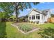 Landscaped backyard with a garden bed, patio seating, and charming exterior details at 1379 Downsberry Dr, Mount Pleasant, SC 29466