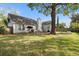 Large backyard featuring a brick patio, mature trees, and a fenced-in yard at 1379 Downsberry Dr, Mount Pleasant, SC 29466