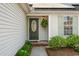 Inviting front entrance with green door, stone pathway, beautiful plants and classic fixtures at 1379 Downsberry Dr, Mount Pleasant, SC 29466