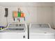 Laundry room with white washer and dryer, wire shelving, and cleaning supplies at 1379 Downsberry Dr, Mount Pleasant, SC 29466