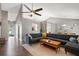 Spacious living room with vaulted ceiling, modern fan, hardwood floors and large sectional couch at 1379 Downsberry Dr, Mount Pleasant, SC 29466