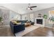 Open concept living room with fire place, hardwood floors and sectional couch at 1379 Downsberry Dr, Mount Pleasant, SC 29466