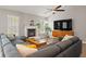 Bright and open living room featuring vaulted ceiling, hardwood floors and large sectional couch at 1379 Downsberry Dr, Mount Pleasant, SC 29466
