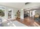 Bright sun room with tile floors and door to patio/yard and opening to dining area at 1379 Downsberry Dr, Mount Pleasant, SC 29466