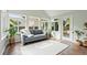 Bright sunroom with tile floors, large windows, and comfortable seating create a cozy and inviting space at 1379 Downsberry Dr, Mount Pleasant, SC 29466