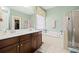 Bathroom featuring double vanity, soaking tub, and glass-enclosed shower at 1440 Teaberry Path, Charleston, SC 29414