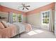 Bedroom with two windows, neutral carpet, and a ceiling fan at 1440 Teaberry Path, Charleston, SC 29414