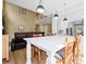 Bright dining area with a large quartz countertop island and dining table, part of an open plan living space at 1440 Teaberry Path, Charleston, SC 29414