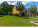 Charming yellow two-story home with a well-manicured lawn and mature landscaping at 1440 Teaberry Path, Charleston, SC 29414