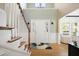 Welcoming foyer with hardwood floors, staircase, high ceilings, and abundant natural light at 1440 Teaberry Path, Charleston, SC 29414