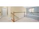 Upstairs hallway with staircase, carpet, and natural light from nearby window at 1440 Teaberry Path, Charleston, SC 29414