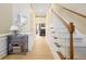 Bright hallway featuring hardwood floors, wainscoting, a staircase, and elegant decor at 1440 Teaberry Path, Charleston, SC 29414