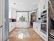 Bright, open kitchen featuring white cabinets, stainless steel appliances, and hardwood floors at 1440 Teaberry Path, Charleston, SC 29414