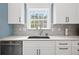 Modern kitchen with stainless steel appliances, white cabinets, and sleek countertops at 1440 Teaberry Path, Charleston, SC 29414