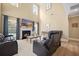 Spacious living room with a fireplace, tall ceilings, and comfortable black recliners at 1440 Teaberry Path, Charleston, SC 29414