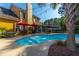 Backyard pool surrounded by lounge chairs and tropical landscaping at 1440 Teaberry Path, Charleston, SC 29414