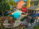 Backyard with a sparkling pool, lounge chairs, and outdoor dining area, creating a perfect relaxation space at 1440 Teaberry Path, Charleston, SC 29414