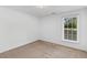 Well-lit bedroom with carpet flooring, showcasing a large window offering natural light and outdoor views at 1530 Fort Johnson Rd # 3C, Charleston, SC 29412