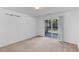 A bright carpeted room featuring a sliding door and view to the outdoor balcony at 1530 Fort Johnson Rd # 3C, Charleston, SC 29412