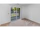 A sun-lit living room with a sliding glass door out to a relaxing outdoor balcony at 1530 Fort Johnson Rd # 3C, Charleston, SC 29412