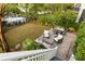 Backyard with outdoor furniture, patio, lawn, and pond bordered with mature trees at 158 Mary Ellen Dr, Charleston, SC 29403