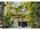 Outdoor seating and dining area surrounded by mature trees and greenery, creating a peaceful retreat at 158 Mary Ellen Dr, Charleston, SC 29403