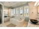 Luxurious bathroom boasts a soaking tub, -and- sinks, and natural stone finishes at 158 Mary Ellen Dr, Charleston, SC 29403