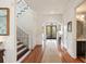 Hallway with wooden floors, staircase with decorative iron railing, and elegant lighting at 158 Mary Ellen Dr, Charleston, SC 29403