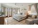 Tranquil main bedroom features hardwood floors, balcony access, and serene decor at 158 Mary Ellen Dr, Charleston, SC 29403