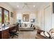 Comfortable office featuring a dark wood desk, gray sofa, and ample natural light at 158 Mary Ellen Dr, Charleston, SC 29403