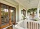 Inviting porch with light green trim, white railings, and french doors at 158 Mary Ellen Dr, Charleston, SC 29403