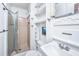 Bright bathroom featuring a glass-enclosed shower, toilet, and vanity with mirror and lighting at 1604 E Ashley Ave, Folly Beach, SC 29439