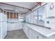 Bright coastal kitchen with white cabinetry, ample counter space, and a view from large windows at 1604 E Ashley Ave, Folly Beach, SC 29439