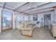 Cozy living room with comfortable seating, tiled floor, and large windows that let in natural light at 1604 E Ashley Ave, Folly Beach, SC 29439