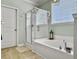 Bright bathroom with a soaking tub, glass-enclosed shower, and a tiled floor at 1673 Emmets Rd, Johns Island, SC 29455