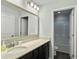 Bright bathroom featuring a large vanity mirror and a view of a separate shower and toilet area at 1673 Emmets Rd, Johns Island, SC 29455