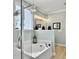 Bright bathroom features a soaking tub with modern fixtures and a separate glass-enclosed shower at 1673 Emmets Rd, Johns Island, SC 29455