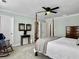 Spacious bedroom with a four-poster bed, sitting chair, and carpet at 1673 Emmets Rd, Johns Island, SC 29455
