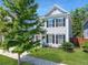Well-maintained two story home featuring classic design elements, a tidy lawn, and mature shade trees at 1673 Emmets Rd, Johns Island, SC 29455