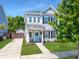 Charming two-story home boasts a welcoming blue door, manicured lawn, and classic architectural details at 1673 Emmets Rd, Johns Island, SC 29455
