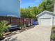 Driveway and detached garage with ample parking space, landscaping and gardening area on the side at 1673 Emmets Rd, Johns Island, SC 29455