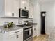 Kitchen with stainless steel appliances, granite countertops and white cabinets, plus a vintage clock at 1673 Emmets Rd, Johns Island, SC 29455