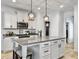 Well-lit kitchen features an island with granite countertops, white cabinets, and pendant lighting at 1673 Emmets Rd, Johns Island, SC 29455