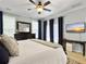 Spacious main bedroom with a large bed, dresser, TV, ceiling fan, and natural light at 1673 Emmets Rd, Johns Island, SC 29455