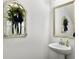Chic powder room featuring stylish decor, a decorative mirror, a vessel sink, and neutral paint at 1673 Emmets Rd, Johns Island, SC 29455