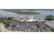This aerial view features a large parking lot, commercial buildings, and docked boats at the marina at 1880 Andell Bluff Blvd # Slip E 9, Johns Island, SC 29455