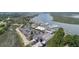 This aerial view includes boats at the marina, commercial buildings with a parking lot, and marshy waterfront at 1880 Andell Bluff Blvd # Slip E 9, Johns Island, SC 29455