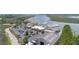 A high-angle view of the marina featuring boats, commercial buildings, parking, and the Bohicket Marina roof at 1880 Andell Bluff Blvd # Slip E 9, Johns Island, SC 29455