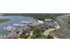 This aerial image shows waterfront condos, the marina with boats, and commercial buildings with parking at 1880 Andell Bluff Blvd # Slip E 9, Johns Island, SC 29455