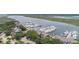 This aerial view displays waterfront condos, boats docked at the marina, and scenic water views at 1880 Andell Bluff Blvd # Slip E 9, Johns Island, SC 29455